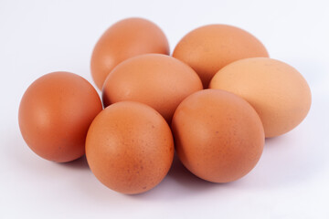 seven eggs are placed on a white background with free space on right