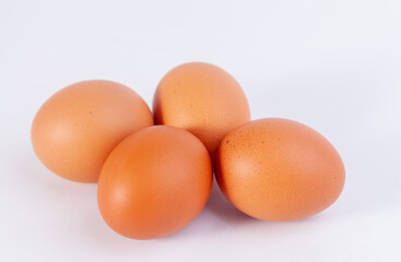 four eggs are placed on a white background with free space on right