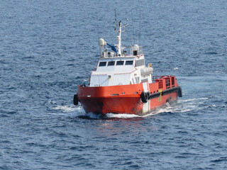 Supply boat transfer the cargo for supporting oil and gas industry and moving cargo from the boat to the platform. Boat is waiting transfer cargo and crews to platform.