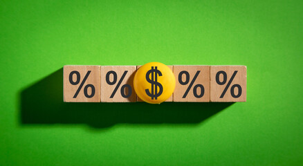 Dollar and percent symbols on wooden cubes.