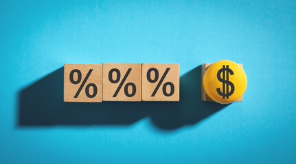 Dollar and percent symbols on wooden cubes.