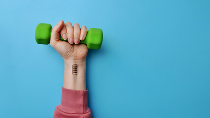 Dumbbells with icons of a charged battery on it in a woman's hand. A symbol of sports as a way to boost energy