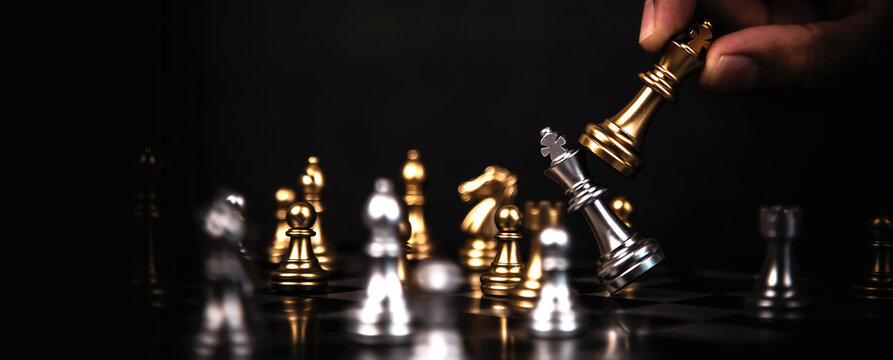 Hand choose king chess fight on chess board concept of team player or business team and leadership strategy and human resources organization management.
