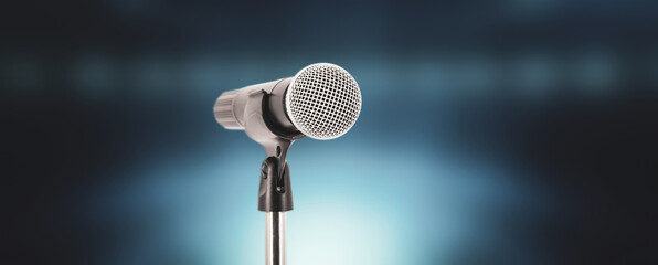 Microphone with stage light background for performance concept of speech comment and public speaking