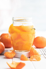 Canned tangerine. Pickled mandarin fruit in jar.