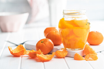 Fototapeta na wymiar Canned tangerine. Pickled mandarin fruit in jar.