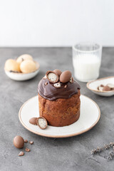 Traditional ukrainian easter cake with chocolate glaze. Easter table with traditional dessert. Easter background. Ukrainian kulich. Chocolate Easter eggs