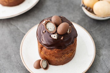 Traditional ukrainian easter cake with chocolate glaze. Easter table with traditional dessert. Easter background. Ukrainian kulich. Chocolate Easter eggs
