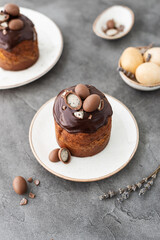 Traditional ukrainian easter cake with chocolate glaze. Easter table with traditional dessert. Easter background. Ukrainian kulich. Chocolate Easter eggs