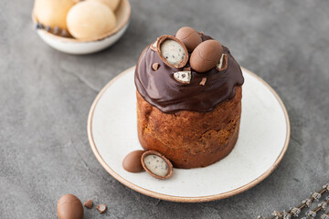 Traditional ukrainian easter cake with chocolate glaze. Easter table with traditional dessert. Easter background. Ukrainian kulich. Chocolate Easter eggs