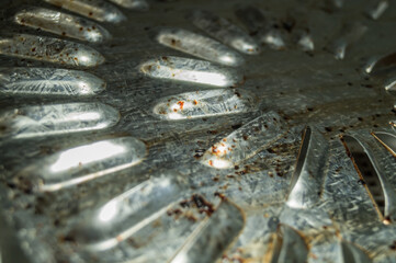 Dirty ventilation grille of electric dryer for vegetables, fruits and meat. Burnt fat on a metal surface. Selective focus