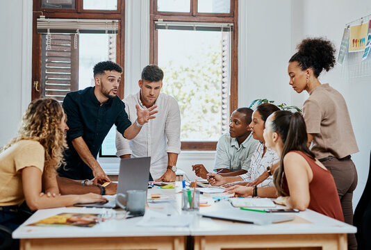 All on board for business success. Shot of a group of young businesspeople having a meeting in a modern office.