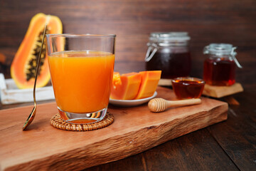 papaya juice, papaya slices on wooden background healthy summer drink