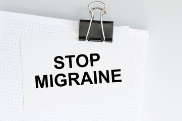 Text on a card Stop Migraine, medical concept