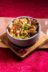 stir fried grouper fish slices in soy sauce on hot stone pot red cloth background chinese halal menu