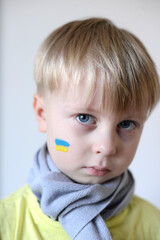 A child with the flag of Ukraine