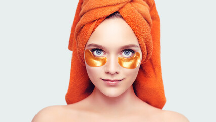 Beauty and health concept young beautiful woman with a towel on her head and patches under her eyes