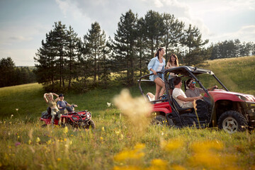 A group of friends riding quads in the nature. Riding, nature, friendship, together