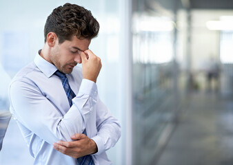 The pressure is just crazy. A young businessman looking stressed-out at the office.