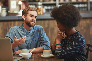 Swapping ideas over coffee. Shot of a young couple enjoying a coffee date. - Powered by Adobe