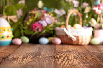 Fototapeta na wymiar Easter time. Easter decorations on the rustic wooden table. Easter bunny, easter eggs in basket. Bouquets of spring flowers. 
