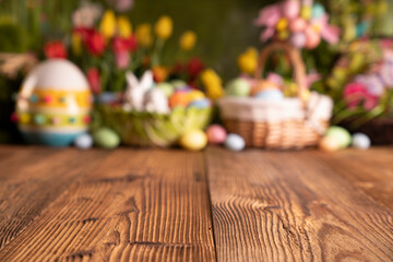 Easter time. Easter decorations on the rustic wooden table. Easter bunny, easter eggs in basket. Bouquets of spring flowers. 