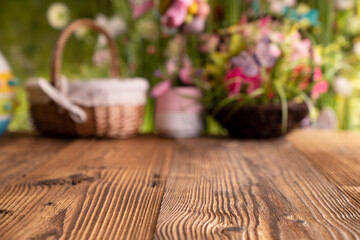 Easter time. Easter decorations on the rustic wooden table. Easter bunny, easter eggs in basket. Bouquets of spring flowers. 