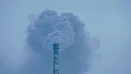 This smoke coming from the chimney in a factory. Harmful emissions into the atmosphere, from the pipe. Serious damage the environment. Plant stack Coaling station. Close up shot. Dark sad view.