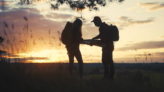 hiker group. team of hikers with backpacks silhouette with map the forest. nature travel a adventure concept. hiker group with backpacks with map lifestyle on the sunset. mountain outdoor view