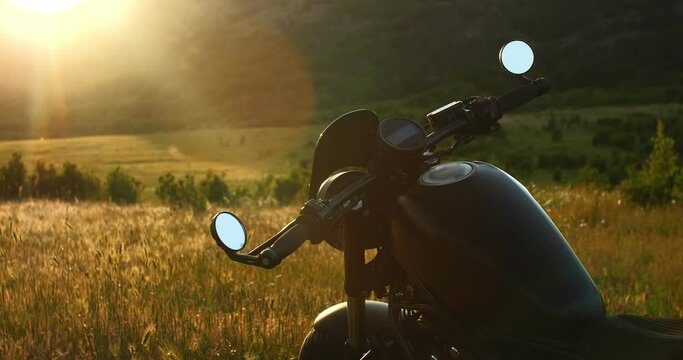 Cool motorcycle on the background of nature in the sun. Video for advertising.