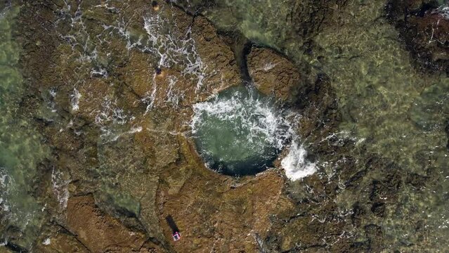 A natural pool is hewn in a natural rock near the shoreline of Haifa, Israel.
