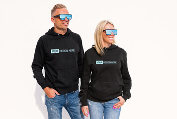Woman and man wearing black hoodies, mockup for your custom hoody sweatshirt design