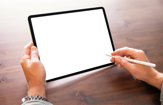 Person working on tablet computer with stylus pen, blank screen mockup