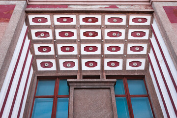A top view of an old building with interesting architecture. TIles on top and blue windows are on the front. Avant-garde style soviet