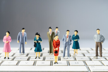 some miniature models on a computer keyboard