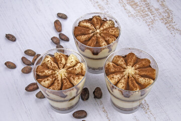 delicious homemade tiramisu in glasses with cocoa beans