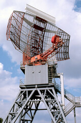 An airport surveillance radar on a bright blue sky background 