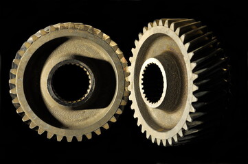 Gear wheels on a black background.