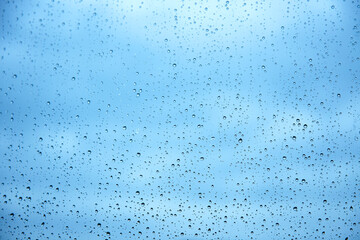 Raindrops on glass and blue sky