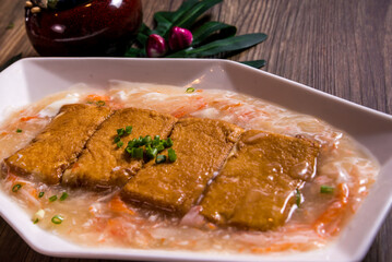 deep fried tofu beancurd with braised mushroom egg crabmeat thick sauce on wood table chinese banquet halal menu