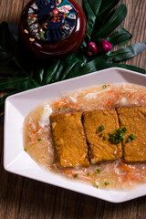 deep fried tofu beancurd with braised mushroom egg crabmeat thick sauce on wood table chinese banquet halal menu