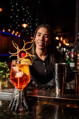 The young Latin brunette prepares a cocktail at the bar counter. job waitress profession
