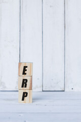 erp concept written on wooden cubes or blocks, on white wooden background.