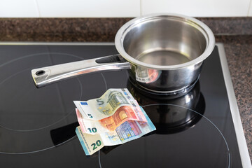 Euro bills on a kitchen with a pot