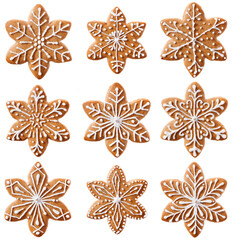 A set of gingerbread cookies in the shape of snowflakes or stars. Various decorations made of sugar...