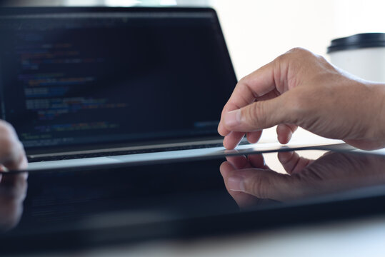Web or application development, technology concept. Programmer, man software engineer, app developer hands coding HTML, programming Javascript on laptop computer