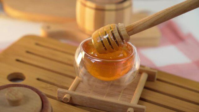 Honey Spoon in Wooden Bowl Close Up Shot. Healthy Food Concept. Healthy sweet food
