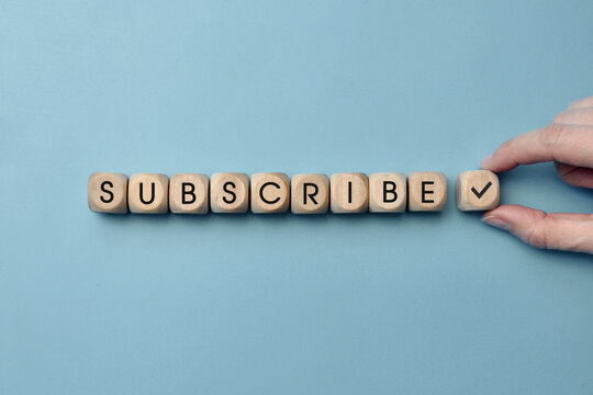 Wooden cubes with the inscription "Subscribe" to them. Internet channel subscription symbol and subscription reminder