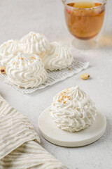 meringue cake with tea on a white parchment