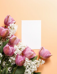 Blank white card and beautiful spring bouquet. Greeting card concept. Mock up blank white paper card for text